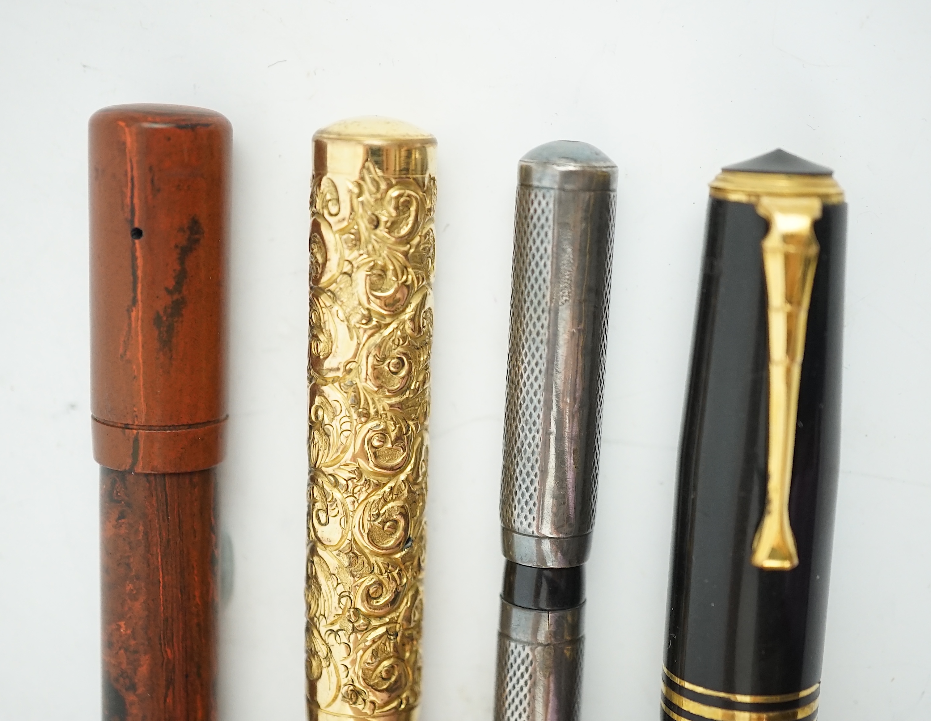 Four sundry fountain pens to include a silver hallmarked Eyedropper